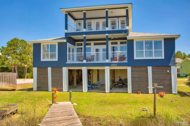 a front view of a building with a garden
