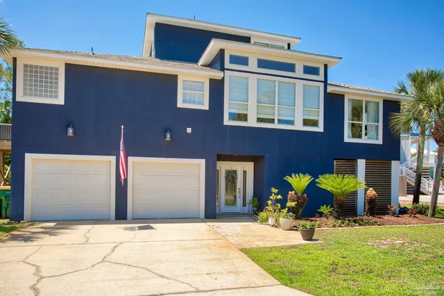 an aerial view of a house with outdoor space swimming pool and ocean view