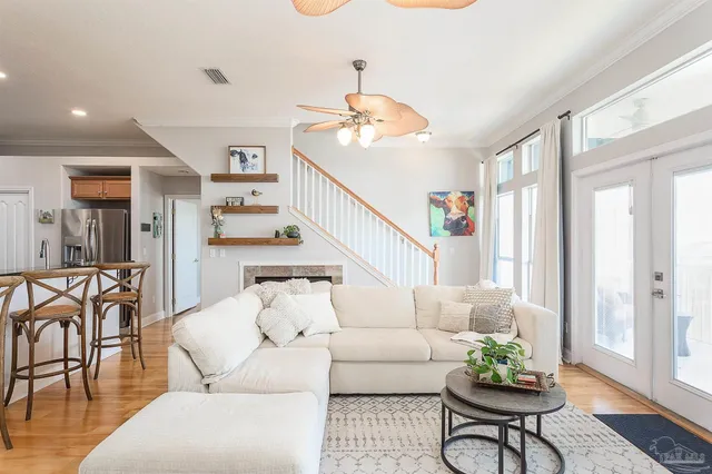 a living room with furniture and wooden floor