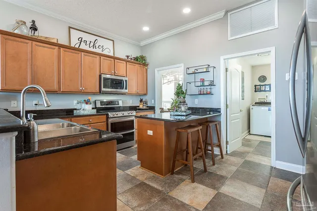 a kitchen with stainless steel appliances granite countertop a stove refrigerator sink and cabinets