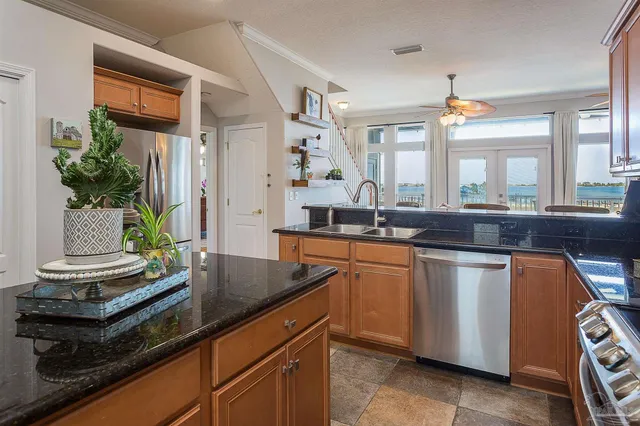 a kitchen with stainless steel appliances granite countertop a sink and a stove
