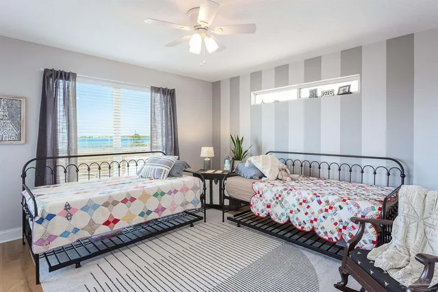 a bedroom with two beds and a window