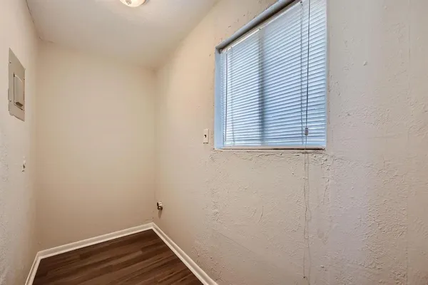a view of small space with wooden floor and a window