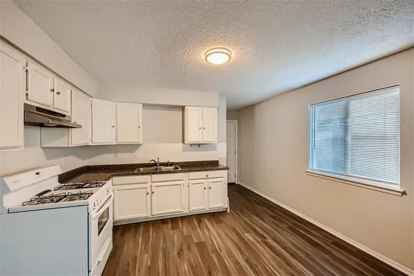 a kitchen with stainless steel appliances granite countertop a stove and a sink