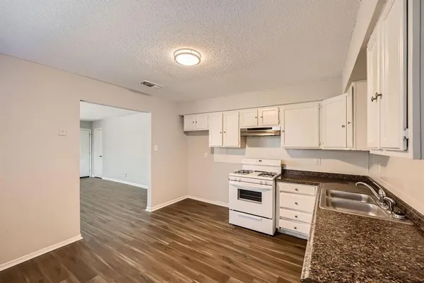 a kitchen with stainless steel appliances granite countertop a stove and a sink