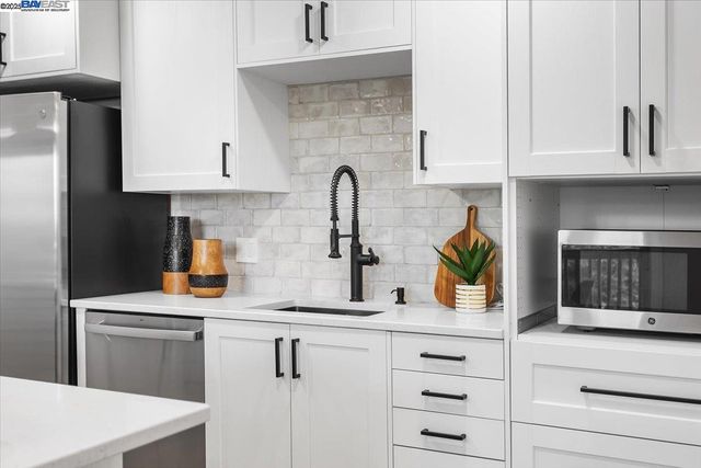 a kitchen with cabinets and appliances