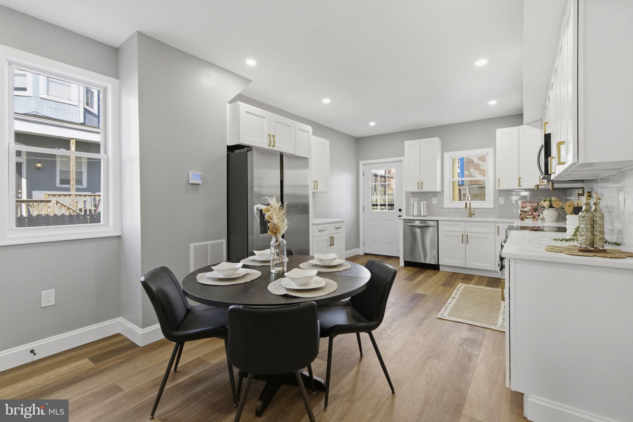 1600 Federal Street Baltimore, MD 21213 - Photo 5 of 31 a kitchen with a dining table chairs and refrigerator