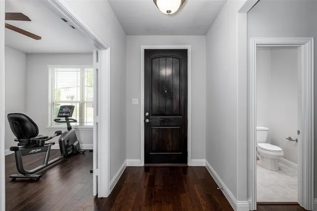 a view of a livingroom with hardwood floor and a bathroom