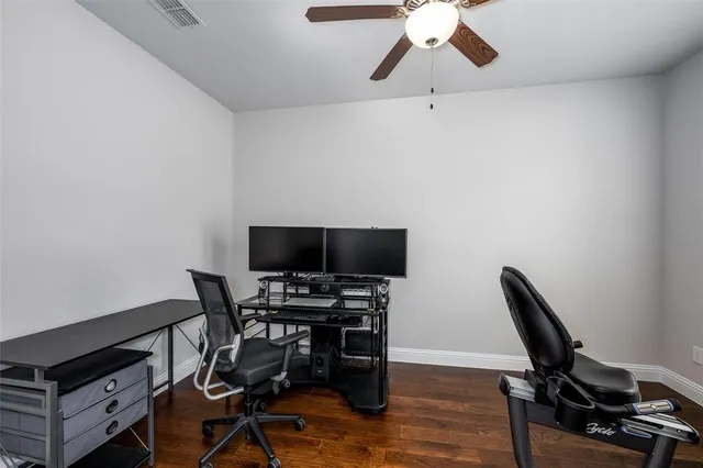 a view of a workspace with furniture and wooden floor