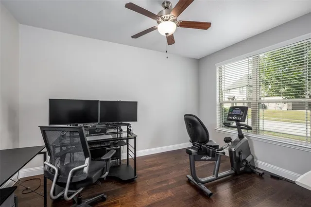 a view of a workspace with furniture and a window