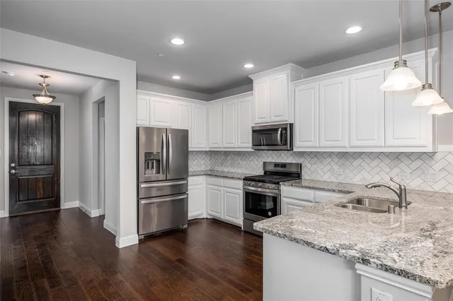a kitchen with a sink stainless steel appliances and cabinets
