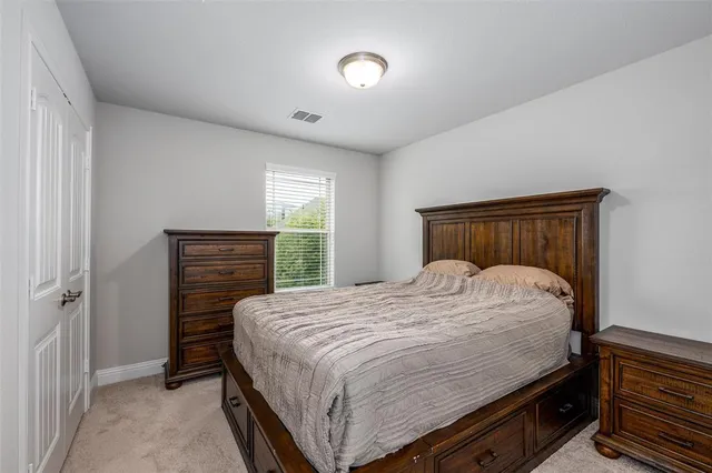 a bedroom with a bed and a dresser