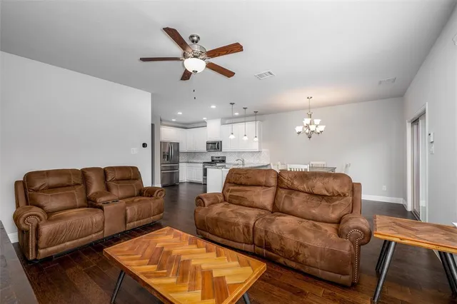 a living room with furniture and kitchen view