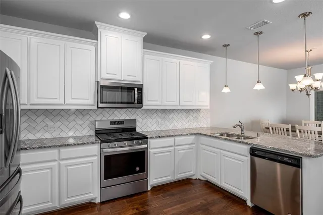 a kitchen with white cabinets and white appliances