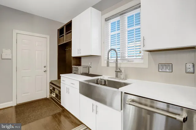 a kitchen with a sink cabinets and window