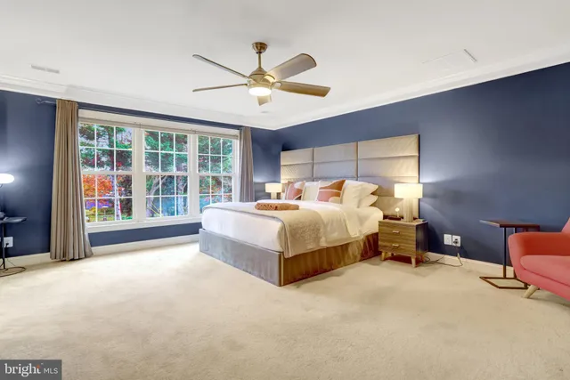 a bedroom with a bed and a large window