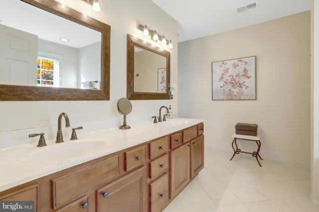 a bathroom with a double vanity sink and a mirror