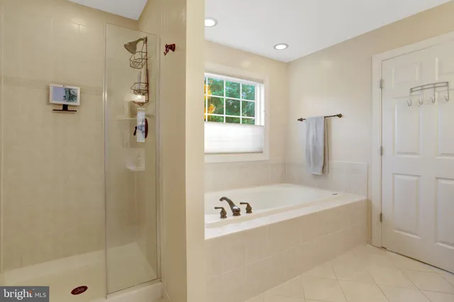 a white bath tub sitting next to a shower