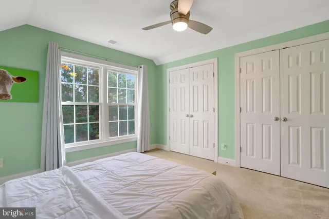 a view of a bedroom with a large bed and large window