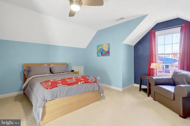 a bedroom with bed and a couch