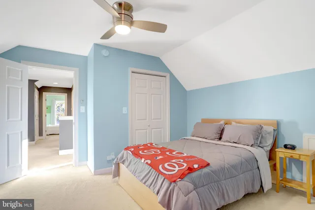 a bedroom with a bed and a mirror