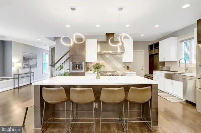 a large kitchen with a table and chairs