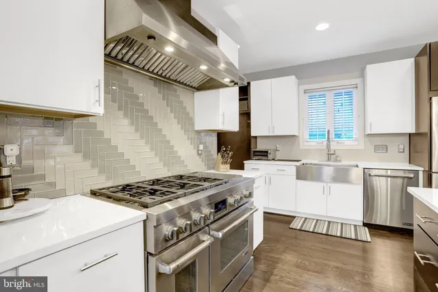 a kitchen with a stove a sink and a refrigerator