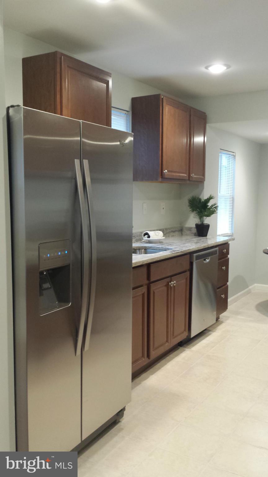 4511 Maple Road Morningside, MD 20746 - Photo 4 of 14 a kitchen with stainless steel appliances granite countertop a refrigerator and a sink