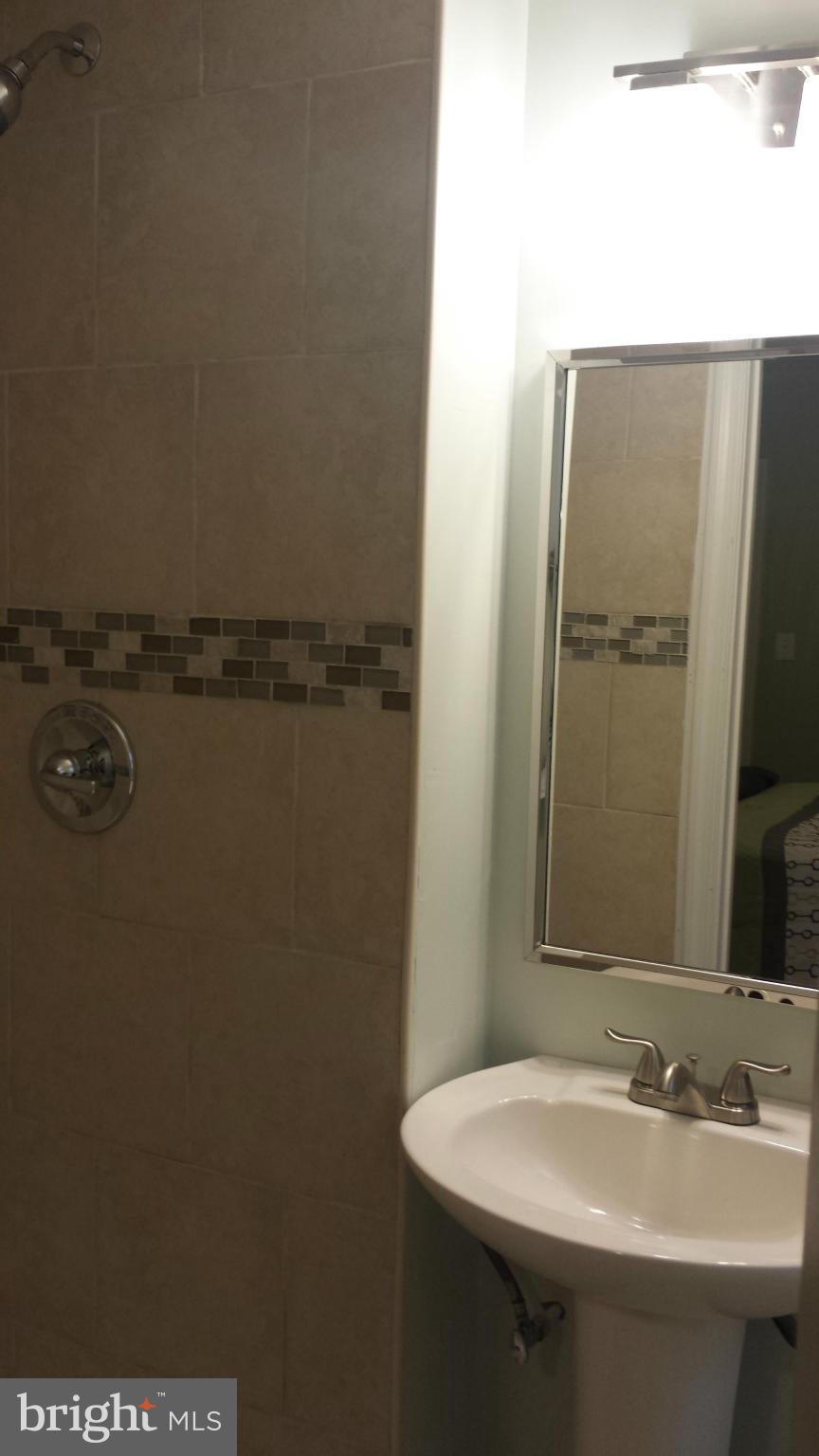 4511 Maple Road Morningside, MD 20746 - Photo 5 of 14 a bathroom with a sink and mirror