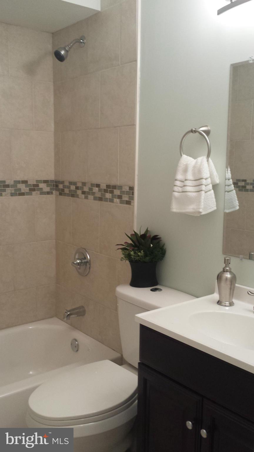 4511 Maple Road Morningside, MD 20746 - Photo 7 of 14 a bathroom with a sink and a bathtub