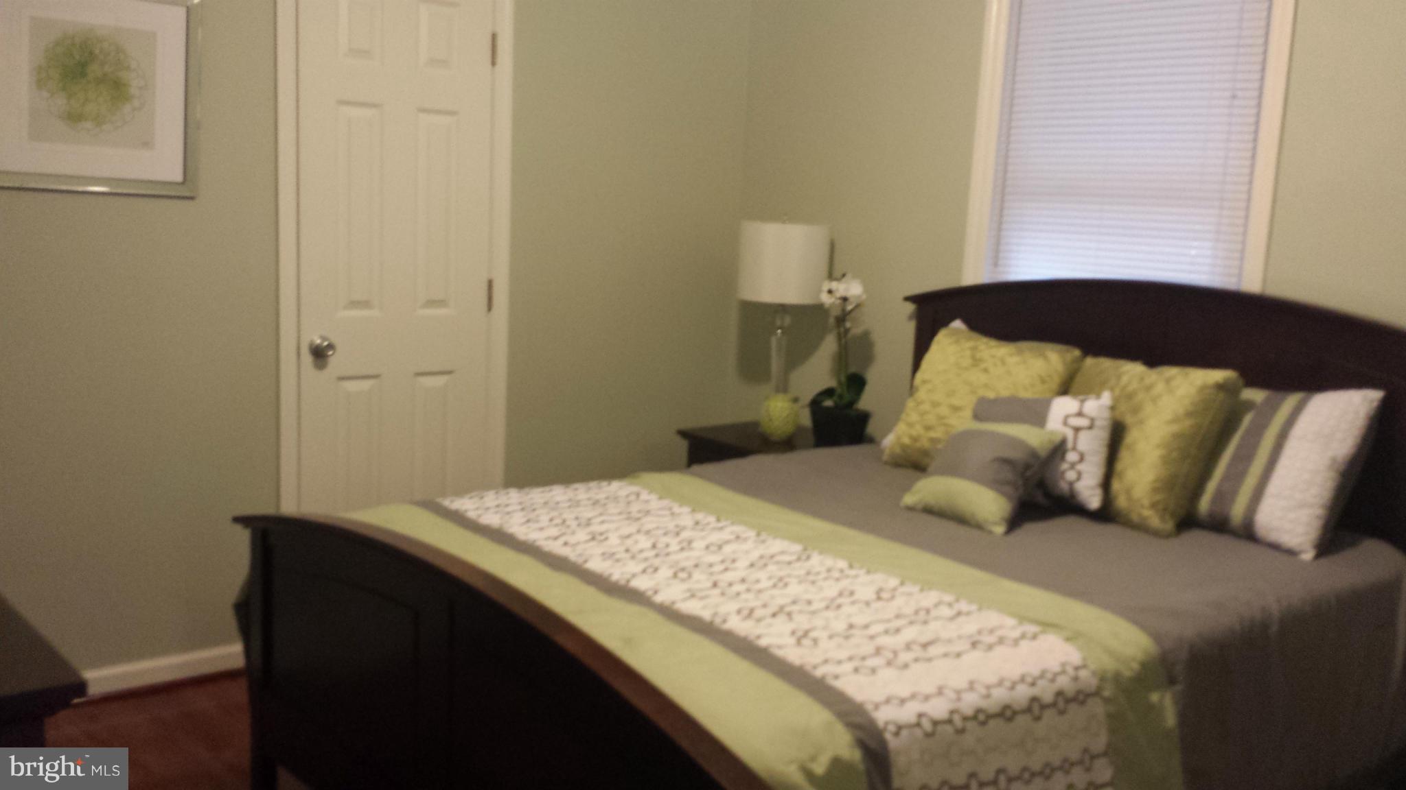 4511 Maple Road Morningside, MD 20746 - Photo 8 of 14 a bedroom with a bed and wooden floor