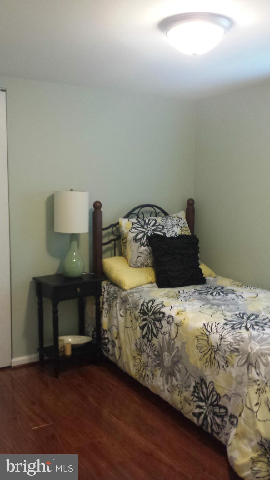 4511 Maple Road Morningside, MD 20746 - Photo 9 of 14 a bedroom with a bed and a table in it