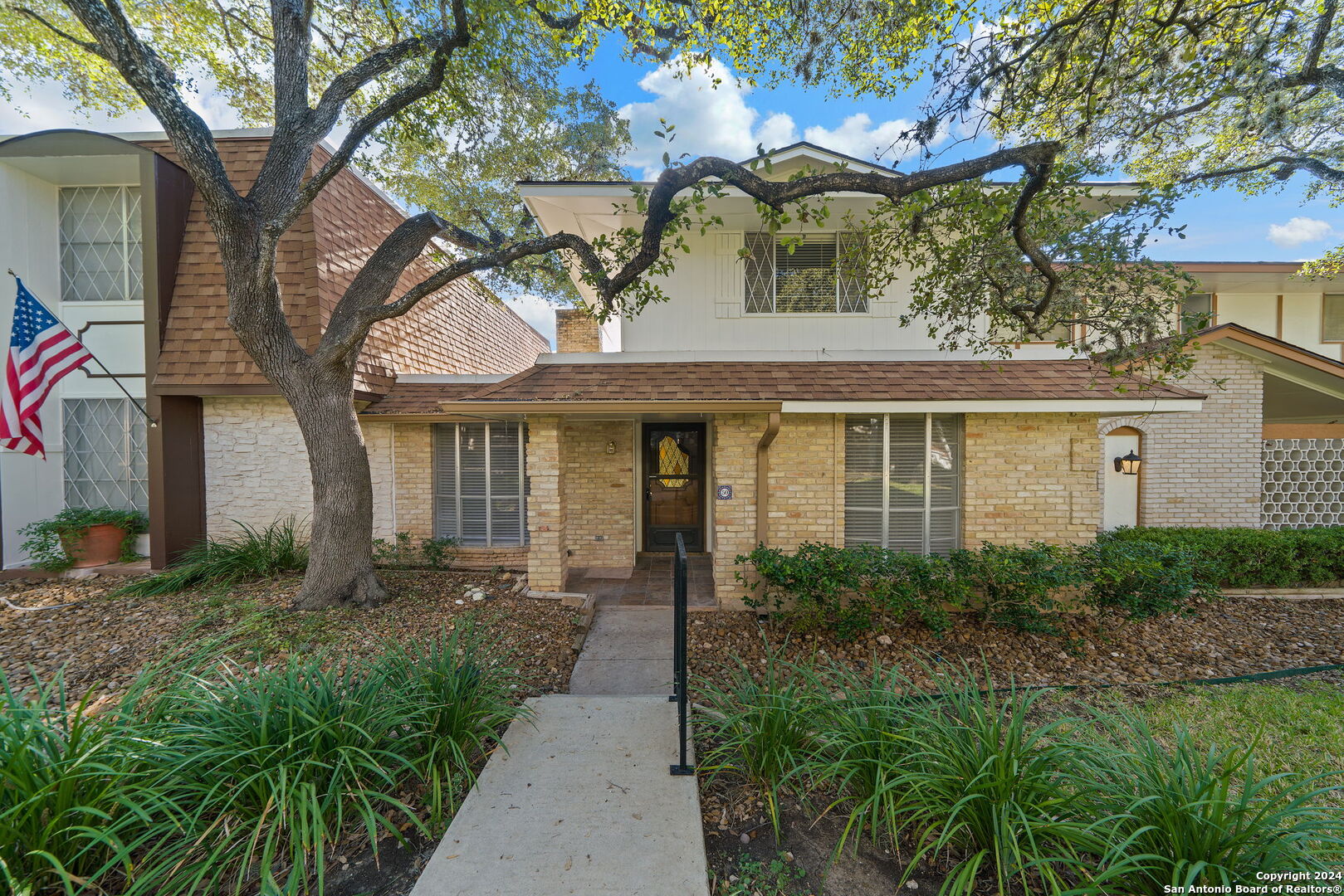 6106 Vance Jackson Road, Unit 50 San Antonio, TX 78230 - Photo 1 of 30 a front view of a house with garden