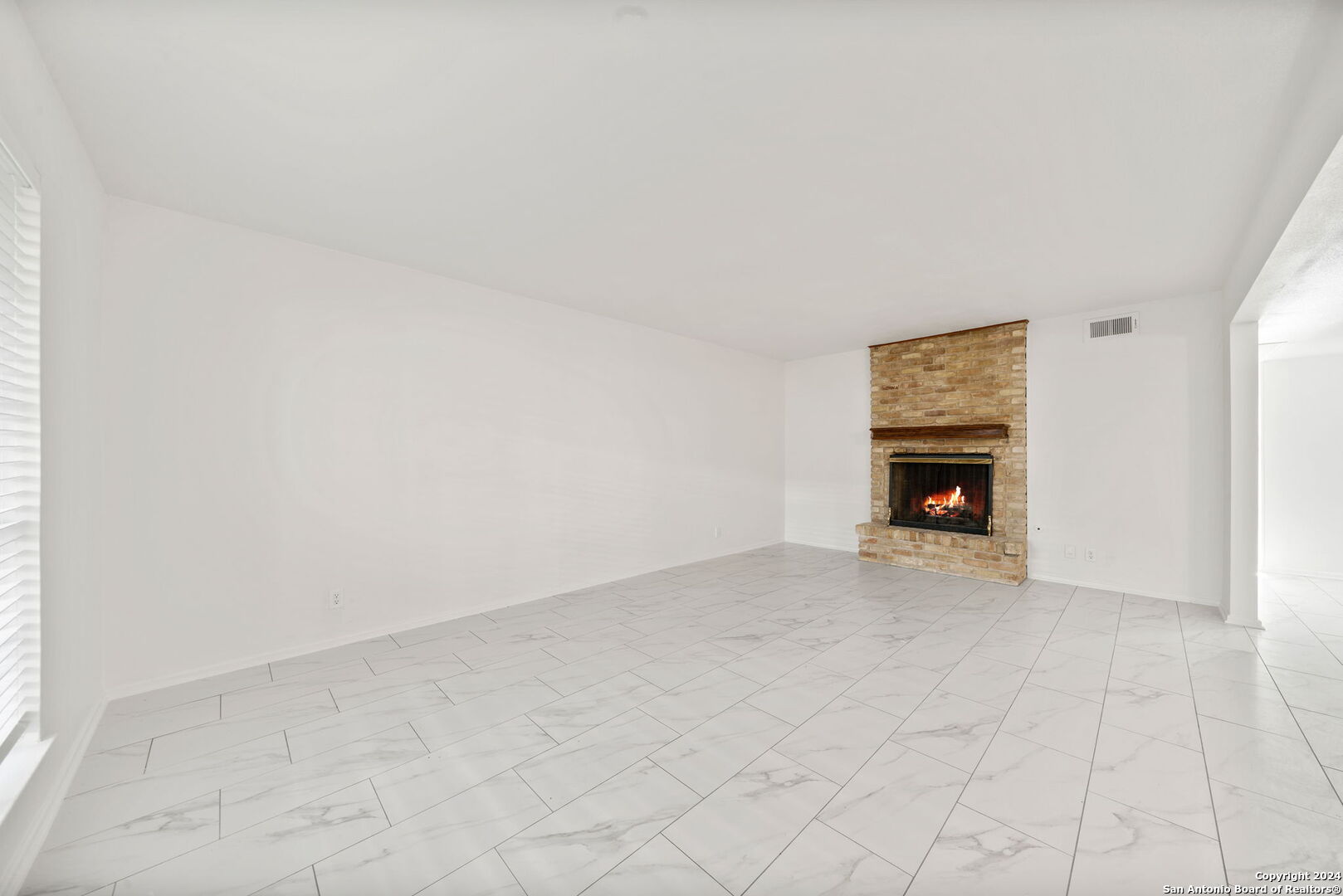 6106 Vance Jackson Road, Unit 50 San Antonio, TX 78230 - Photo 11 of 30 a view of an empty room with a fireplace and a window
