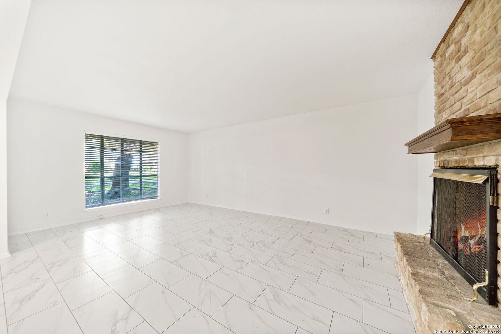 6106 Vance Jackson Road, Unit 50 San Antonio, TX 78230 - Photo 13 of 30 a view of empty room with window and fireplace