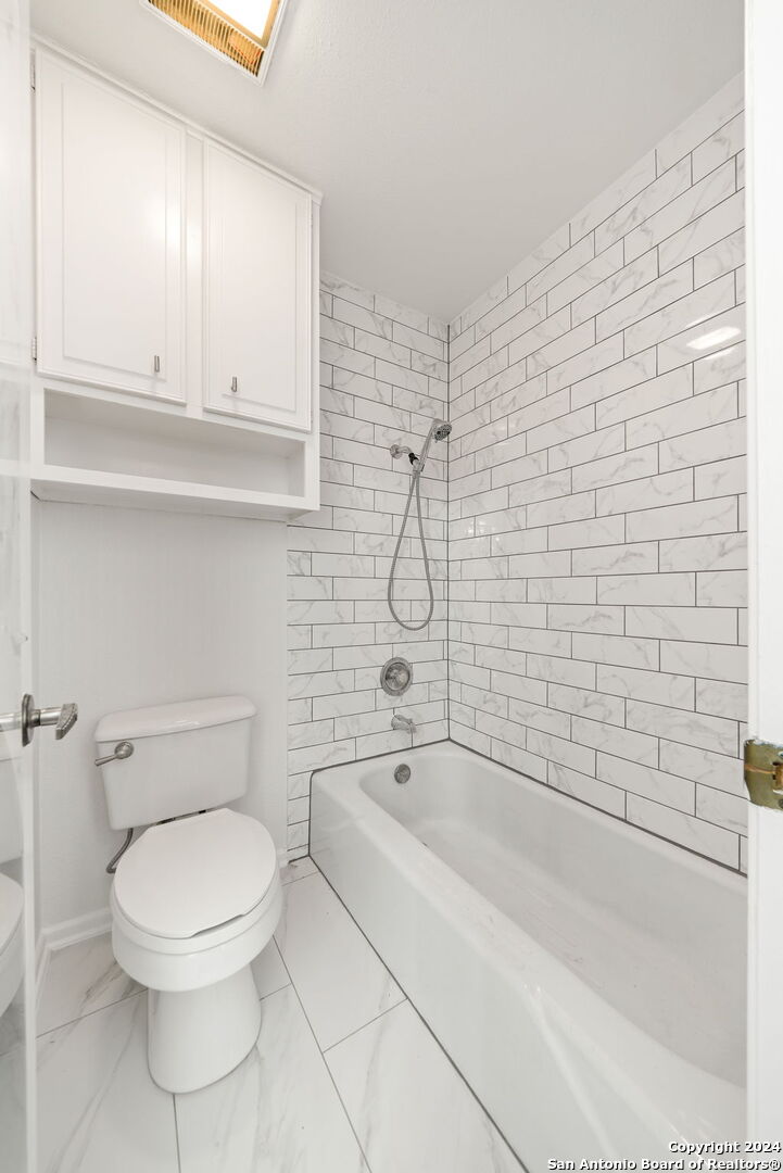 6106 Vance Jackson Road, Unit 50 San Antonio, TX 78230 - Photo 25 of 30 a bathroom with a toilet and a shower