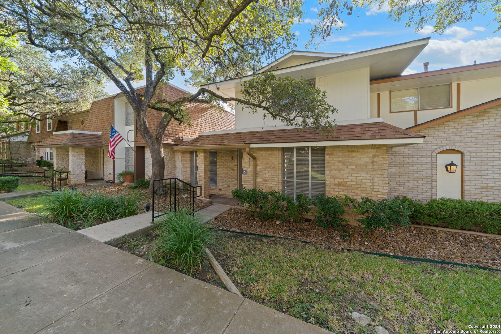 6106 Vance Jackson Road, Unit 50 San Antonio, TX 78230 - Photo 3 of 30 a front view of a house with garden