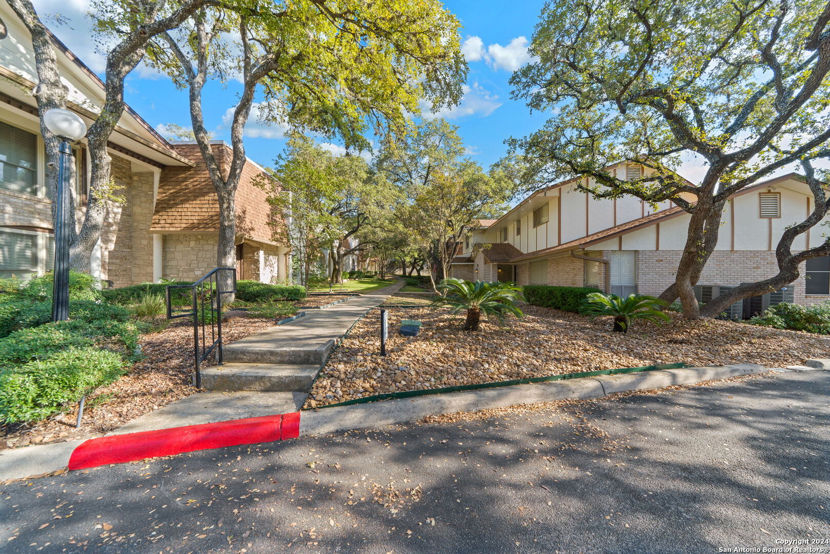 6106 Vance Jackson Road, Unit 50 San Antonio, TX 78230 - Photo 5 of 30 a view of road with large trees