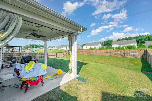 a view of backyard with trampoline