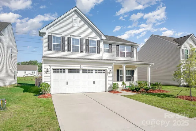 a front view of a house with a garden and plants