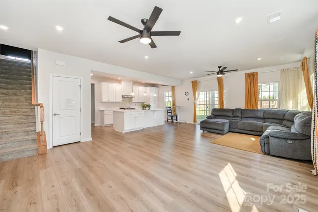 a living room with furniture and kitchen view