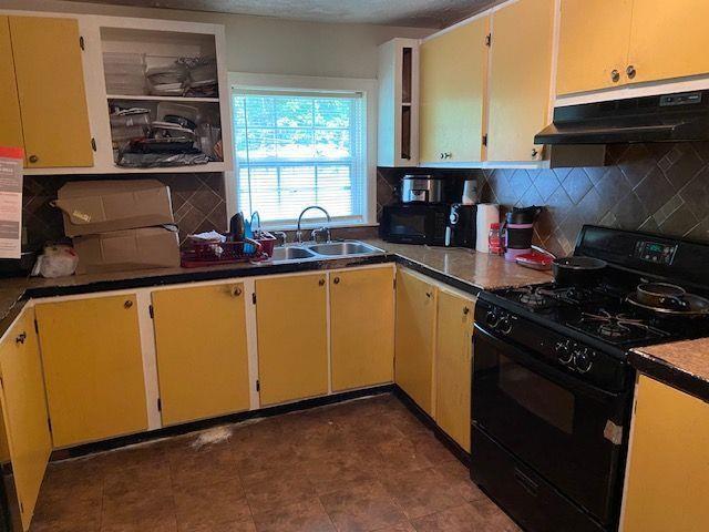 4231 Blanton Avenue Southwest Atlanta, GA 30331 - Photo 4 of 10 a kitchen with granite countertop a stove and a sink