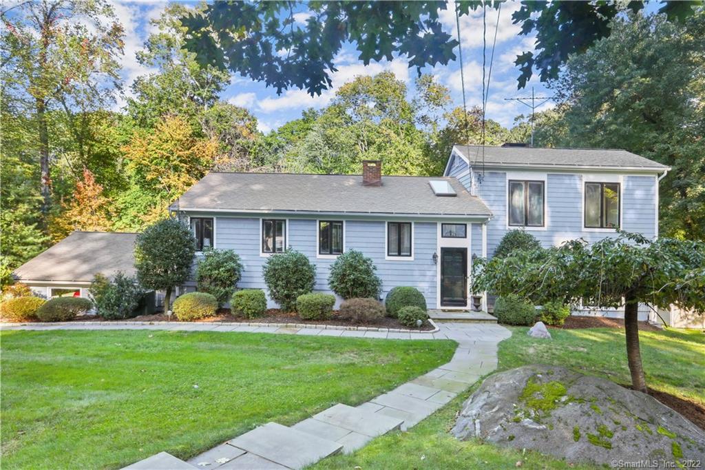 59 Quaker Ridge Road Stamford, CT 06903 - Photo 1 of 1 a front view of a house with a yard and trees