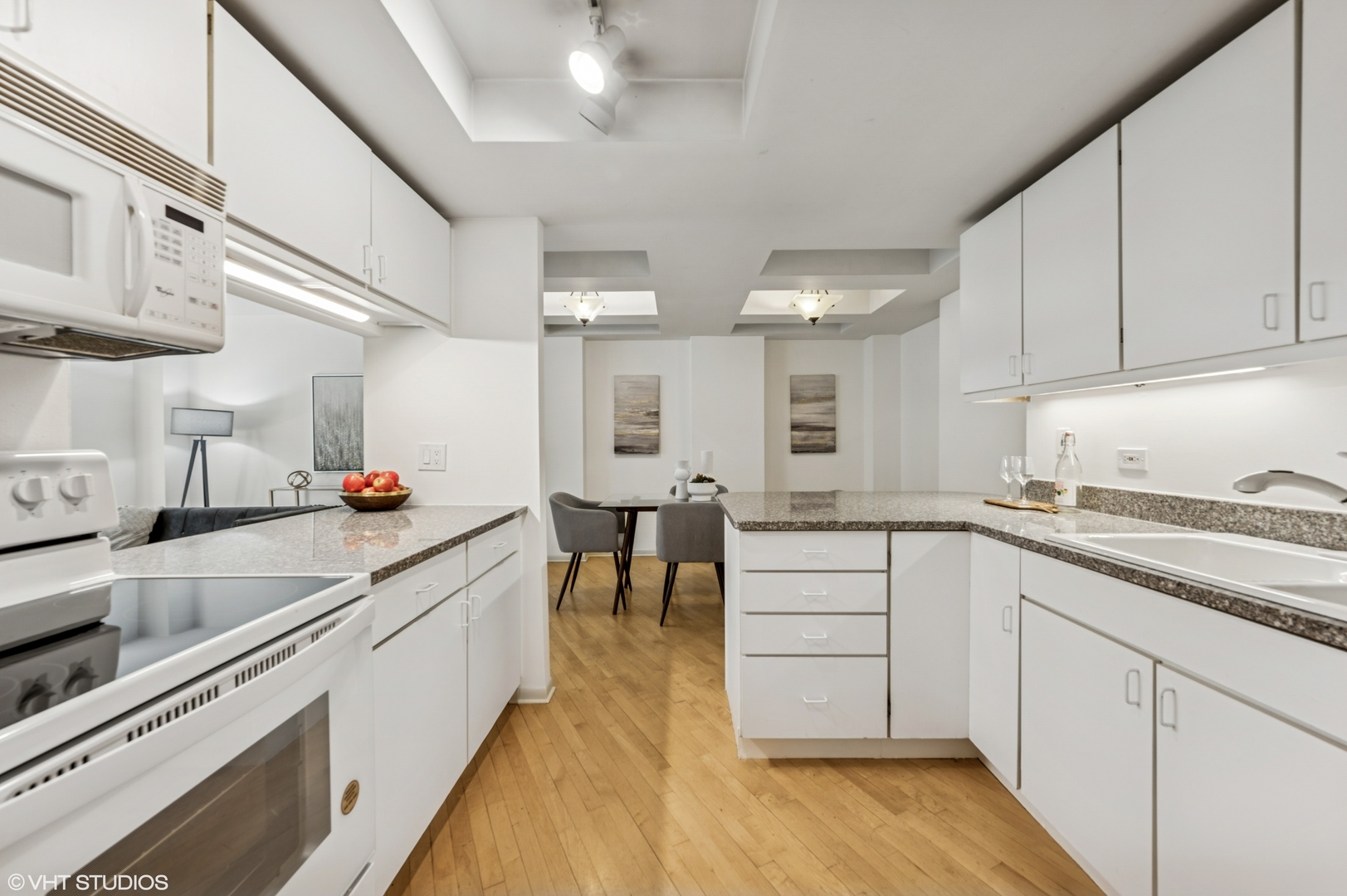 40 East Delaware Place, Unit 301 Chicago, IL 60611 - Photo 11 of 21 a large white kitchen with lots of counter space a sink and appliances