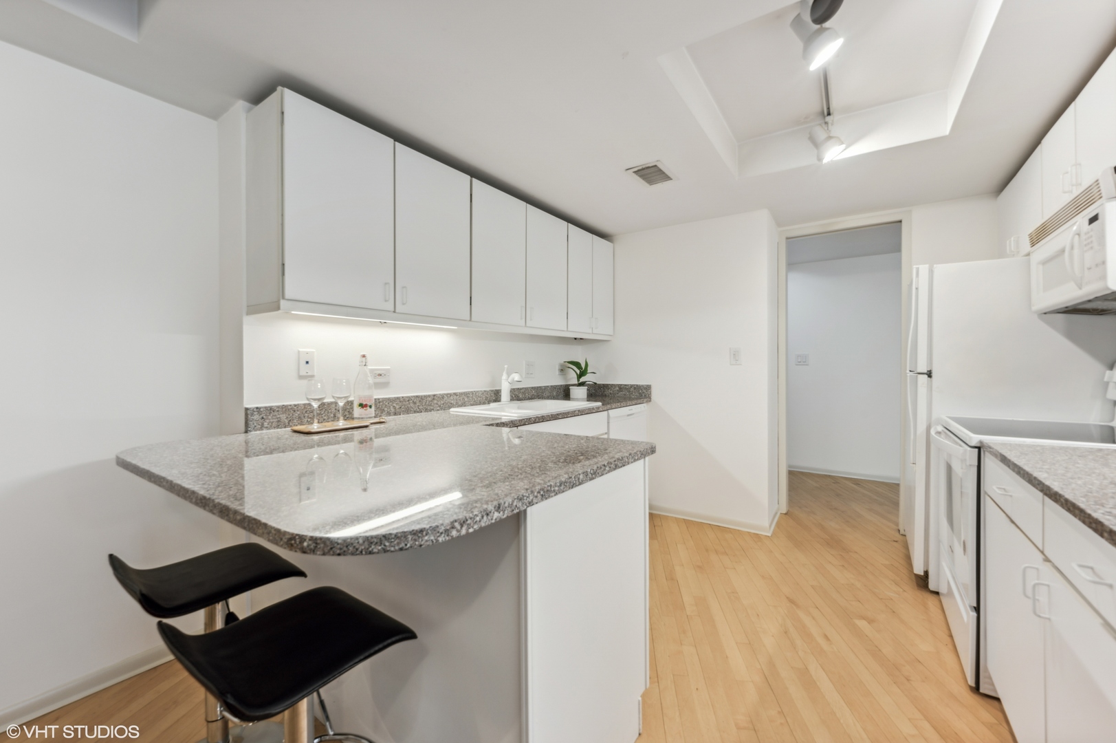 40 East Delaware Place, Unit 301 Chicago, IL 60611 - Photo 12 of 21 a kitchen with a sink cabinets and a stove