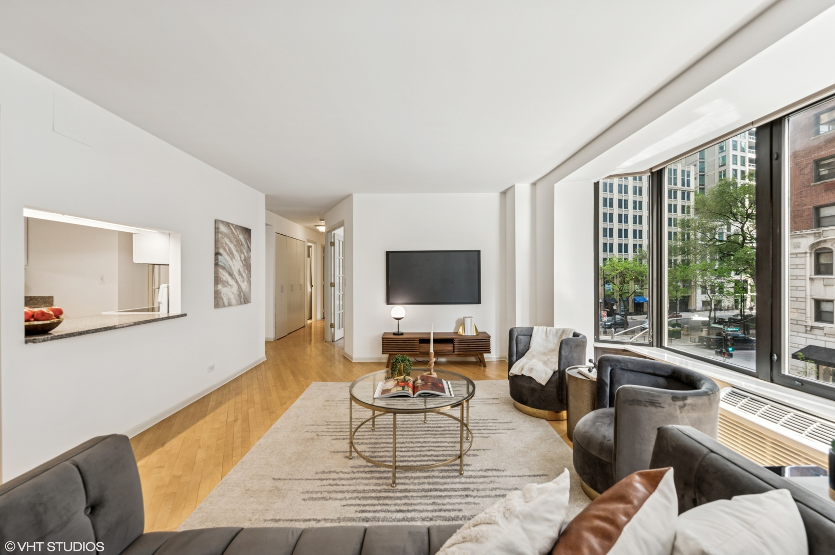40 East Delaware Place, Unit 301 Chicago, IL 60611 - Photo 5 of 21 a living room with furniture large window and a flat screen tv