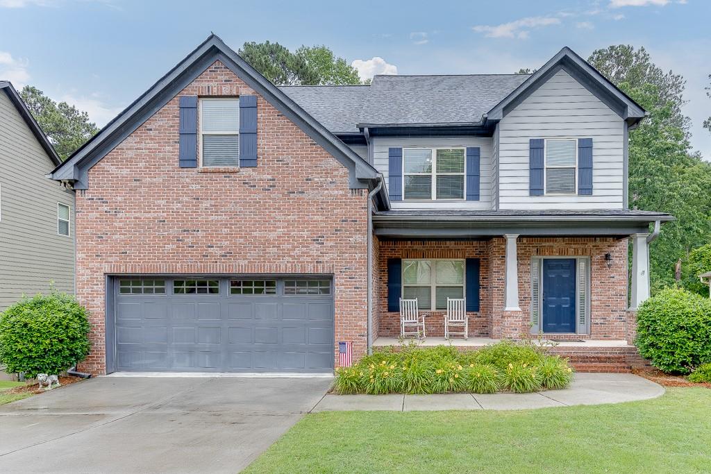 5582 Leaf Ridge Lane Northeast Buford, GA 30518 - Photo 1 of 1 a front view of a house with garden
