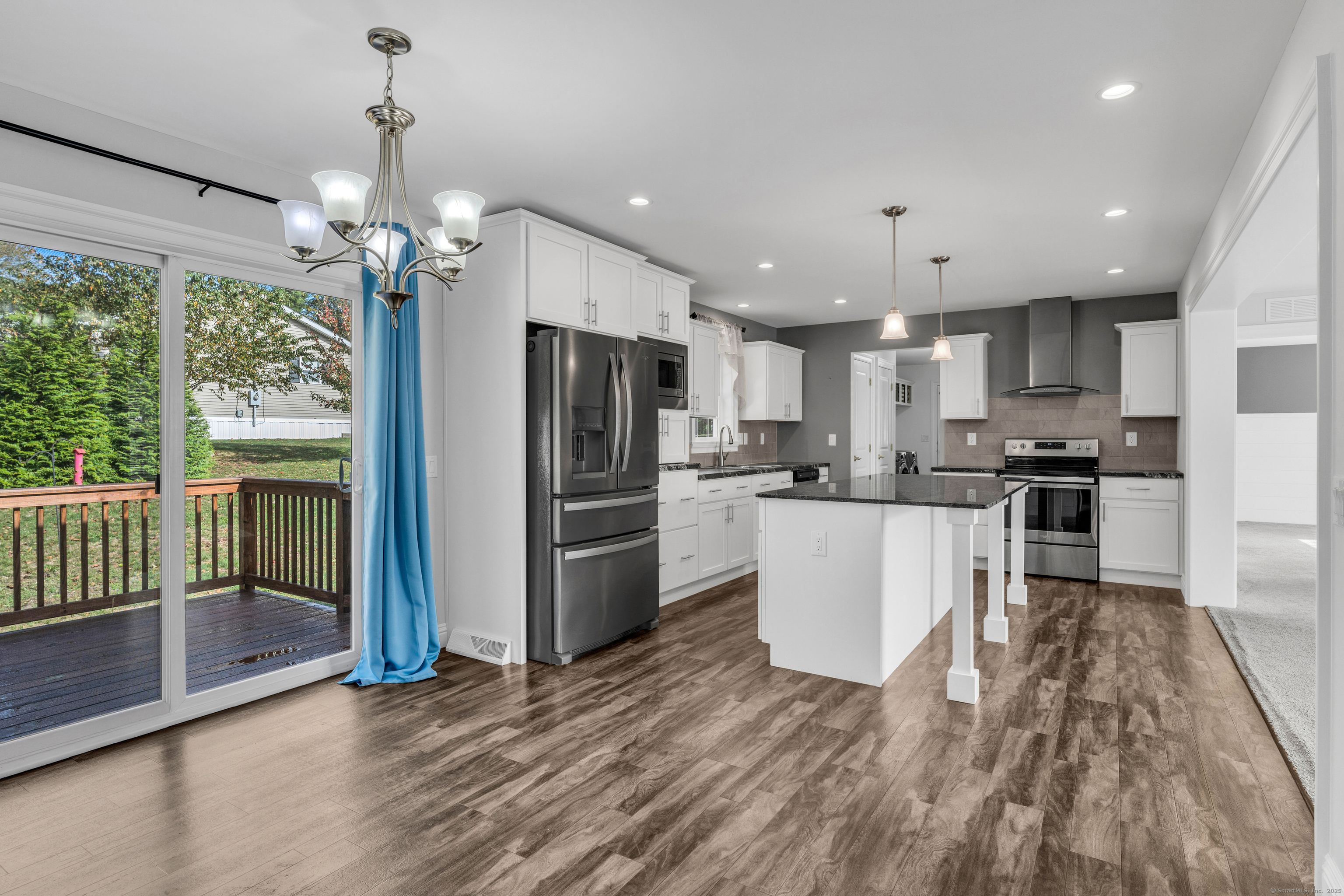 1 High Ridge Circle Montville, CT 06382 - Photo 13 of 39 a kitchen with stainless steel appliances granite countertop a refrigerator a oven a sink a island and chairs with wooden floor