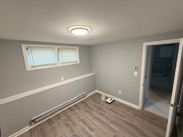 2 Gladeside Terrace, Unit 1 Boston, MA 02126 - Photo 16 of 20 an empty room with wooden floor and windows