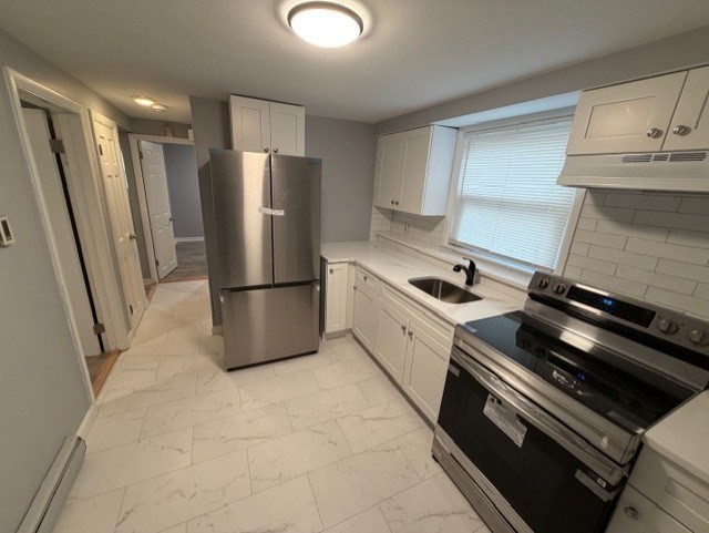 2 Gladeside Terrace, Unit 1 Boston, MA 02126 - Photo 5 of 20 a kitchen with stainless steel appliances a refrigerator and a stove top oven